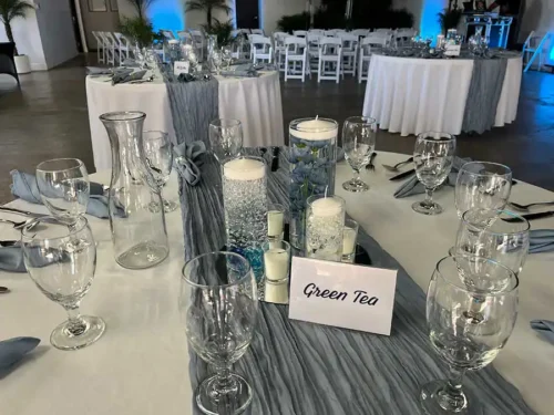 Elegant wedding reception table with gray table runner, candles, glassware, and modern place settings at a luxury wedding venue in Palm Springs, California.
