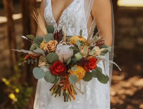 Bride holding a luxury bridal bouquet with elegant seasonal flowers designed for a San Diego wedding by Butterfly Soiree.
