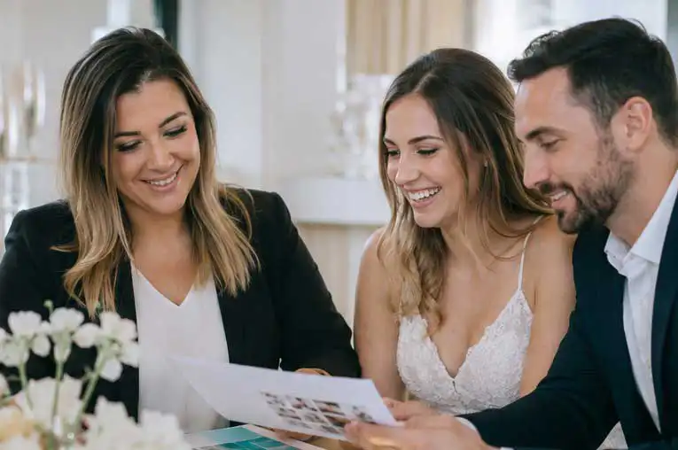 Luxury wedding planner meeting with a bride and groom to discuss wedding planning details in San Diego.