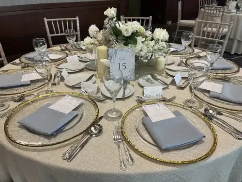 Elegant wedding reception table with white floral centerpieces and luxury place settings designed for a Santa Barbara wedding.