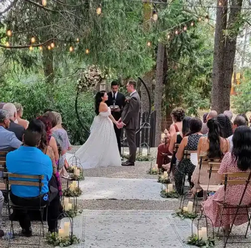 Bride and groom sharing a romantic moment during an elegant outdoor wedding in California.