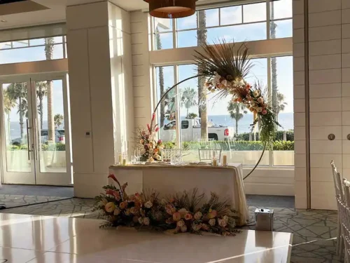 Wedding sweetheart table with circular floral arch and ocean view in Dana Point California.