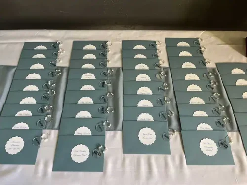 Elegant wedding escort cards with guest names and table assignments displayed on a reception table at a luxury wedding in Sonoma, California.