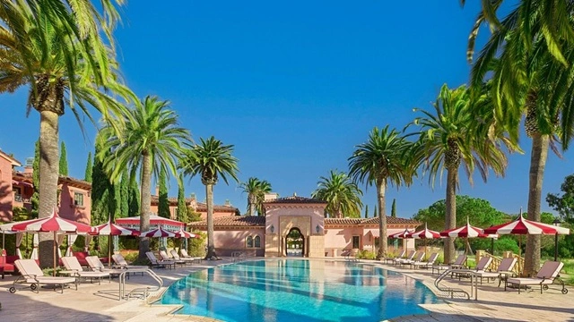 Fairmont Grand Del Mar luxury wedding venue with a resort pool, palm trees, and Mediterranean-style architecture