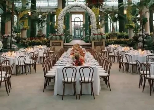 Elegant outdoor estate wedding ceremony surrounded by gardens and trees